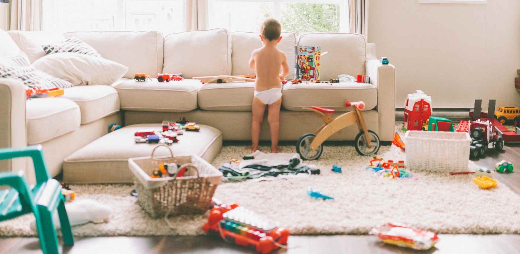 potty trained toddler in a messy room